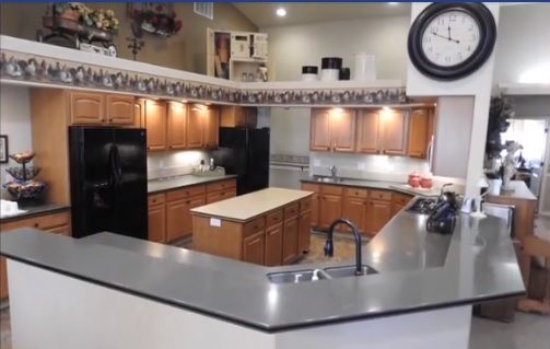 Senior resident in the well-equipped kitchen of The Cottages of Emmett senior living community.