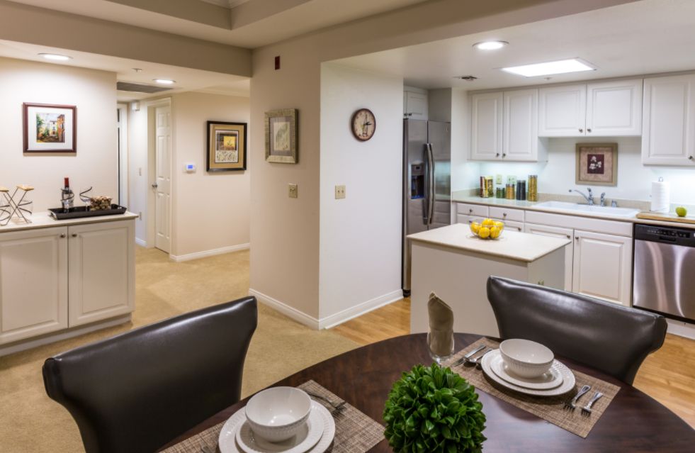 Interior view of Royal Oaks senior living community featuring a well-designed kitchen and living room.