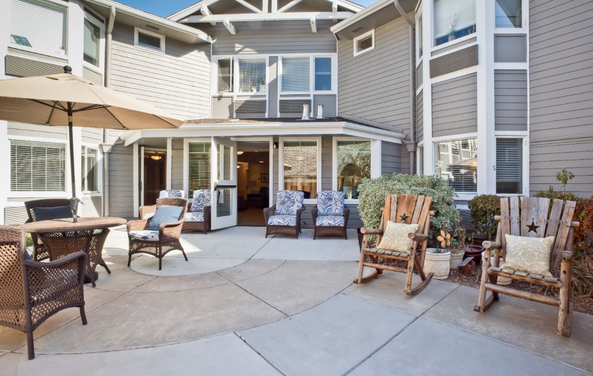 Senior living community Ivy Park at Walnut Creek featuring patio furniture, housing architecture.