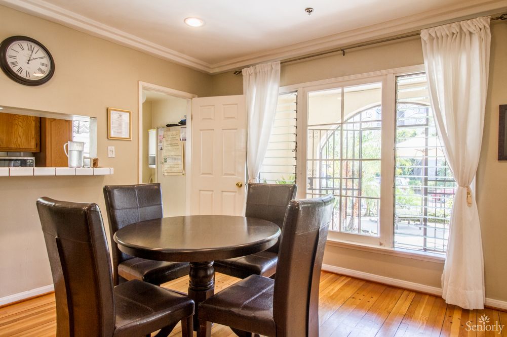 Interior view of Astoria 2 senior living community featuring hardwood flooring and elegant furniture.