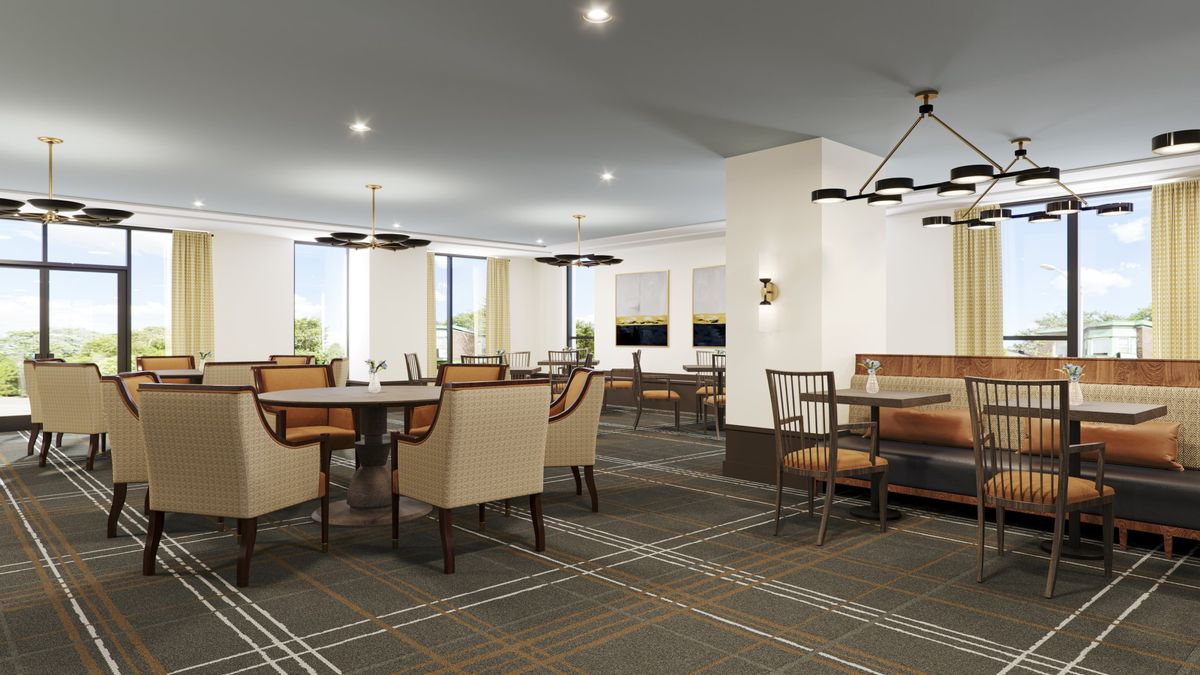 Interior view of Oak Park senior living community featuring dining area and lounge with elegant decor.
