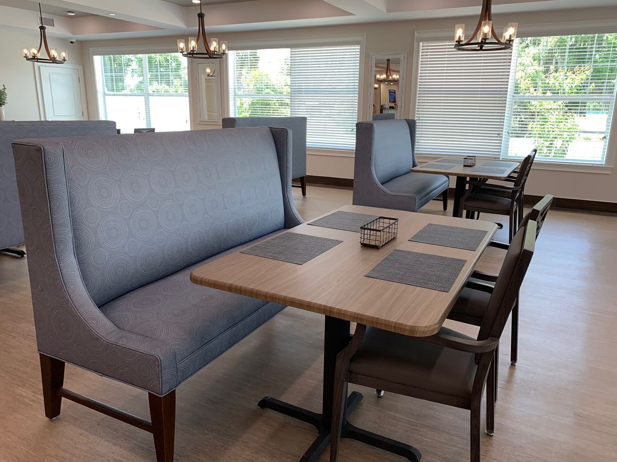 Interior view of Grace Manor at Hunters Creek senior living community featuring elegant dining room decor.
