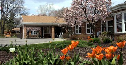 St. Anne's Mead senior living community with lush gardens and modern villas in a city landscape.