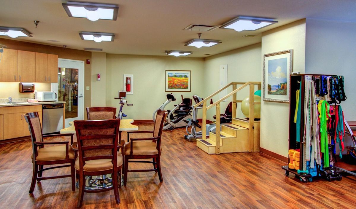Interior view of The Forum at Overland Park senior living community featuring furniture, appliances, and art.