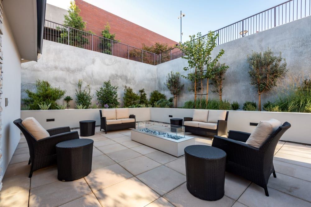 Terrace view of Merrill Gardens at Rolling Hills Estates senior living community with outdoor furniture.