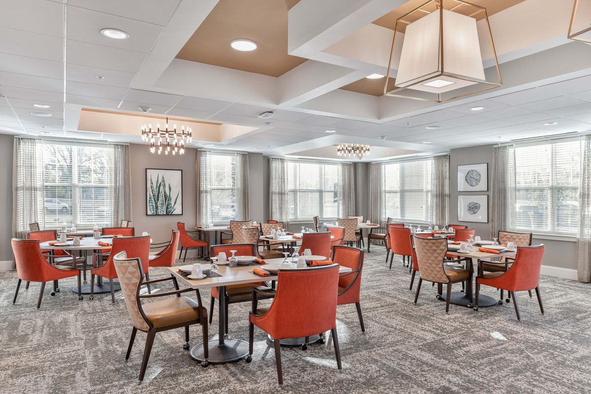 Interior view of Anthology of Farmington Hills senior living community featuring dining area and lounge.