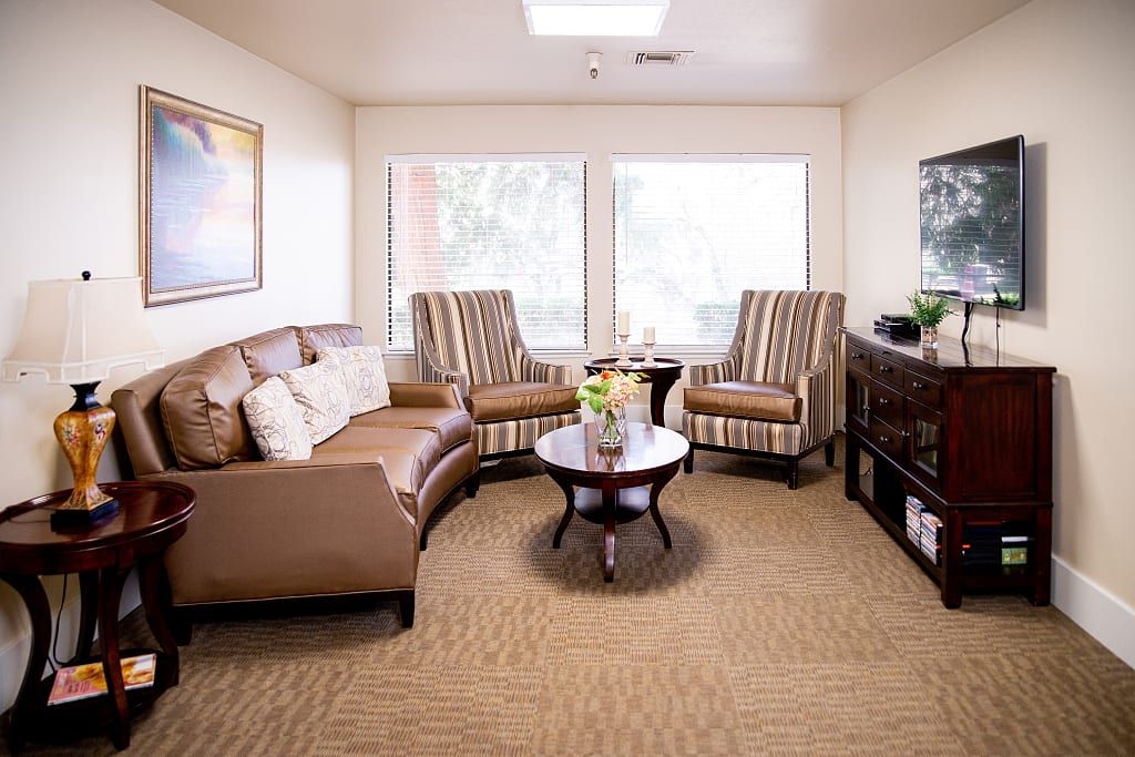 Interior view of Astoria Senior Living at Oakdale featuring cozy living room with modern decor and electronics.