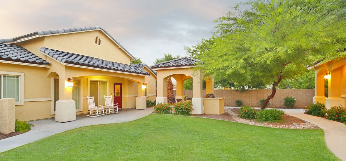 Visions Assisted Living at Mesa, a resort-style senior community with lush lawns and hacienda architecture.