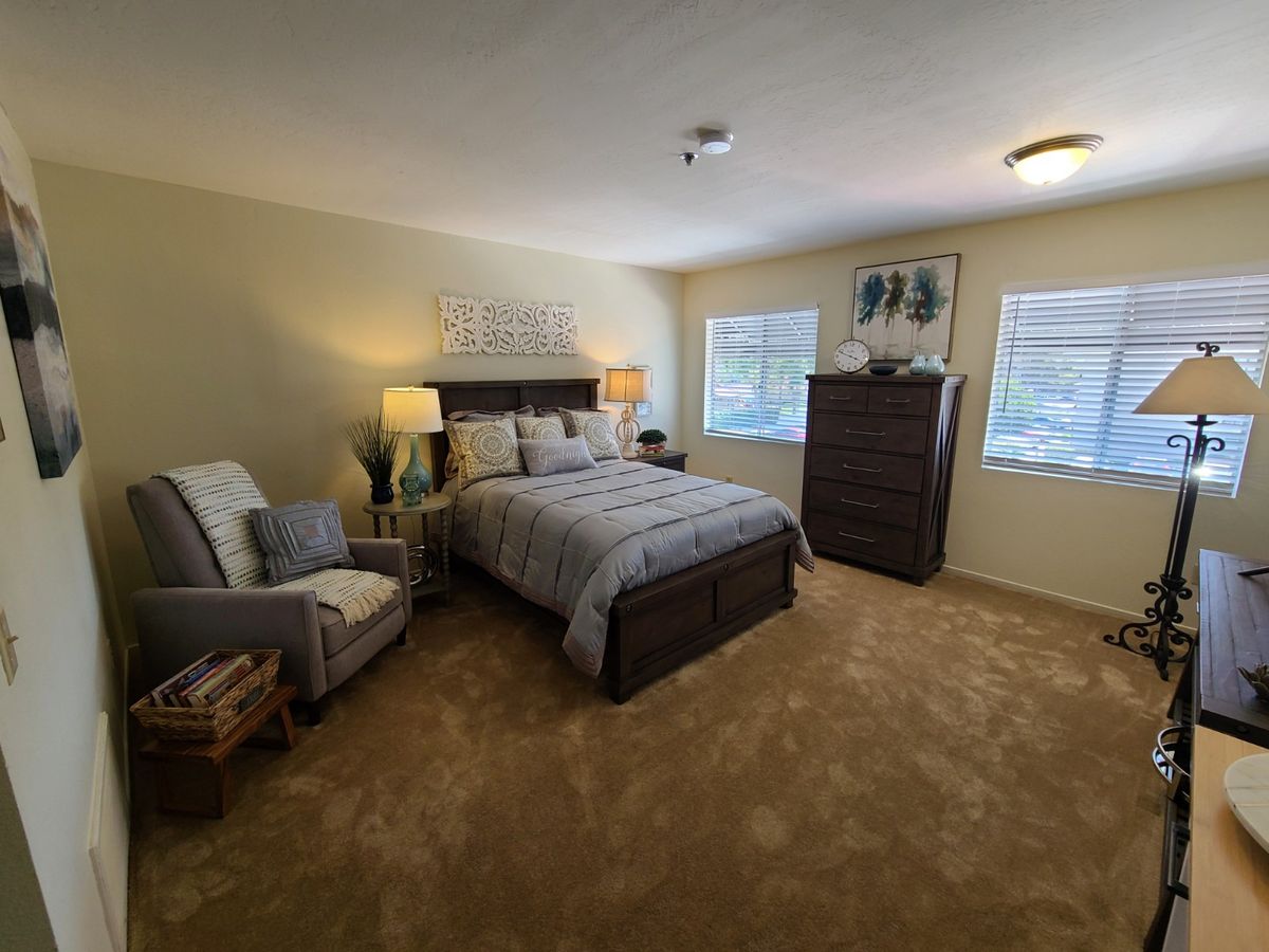 Interior view of a bedroom at Silvergate San Marcos senior living community with modern decor.