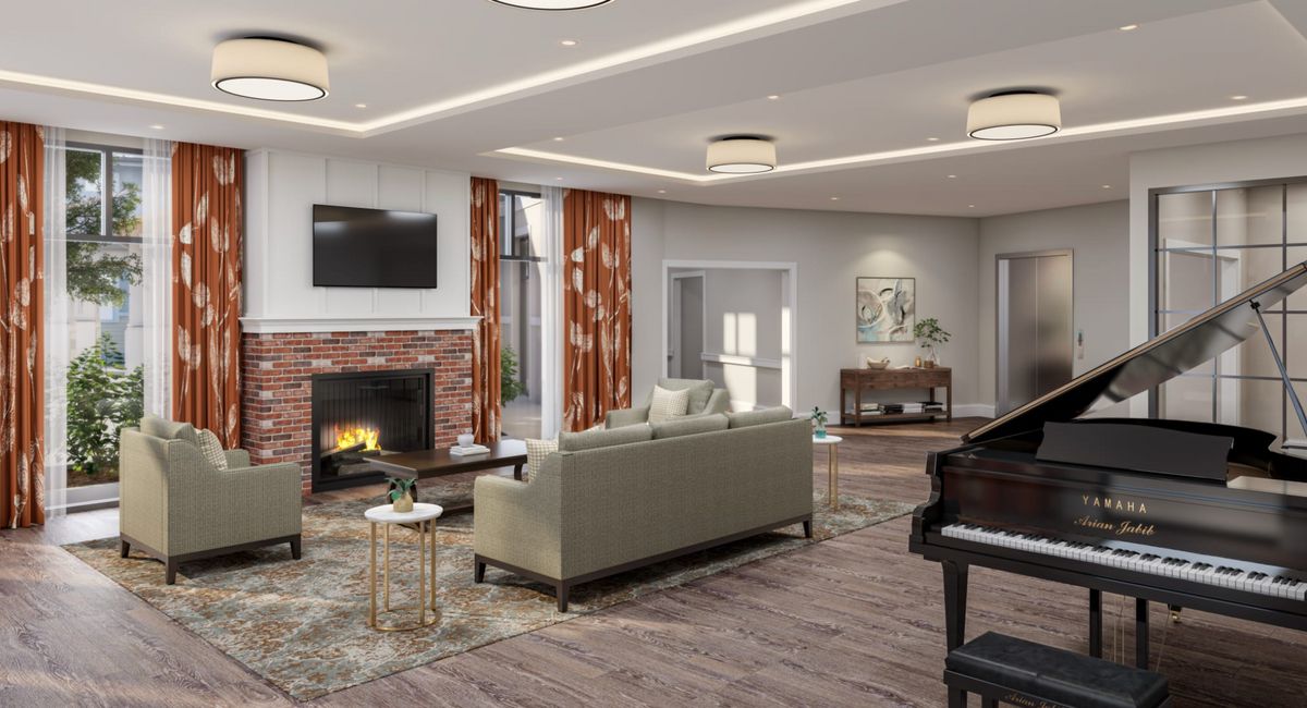 Senior living room at The Residence at Bedford with piano, fireplace, and modern decor.