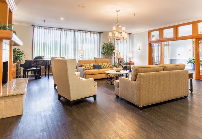 Elegant interior of Windsor Court Assisted Living with stylish decor, furniture, and chandelier.