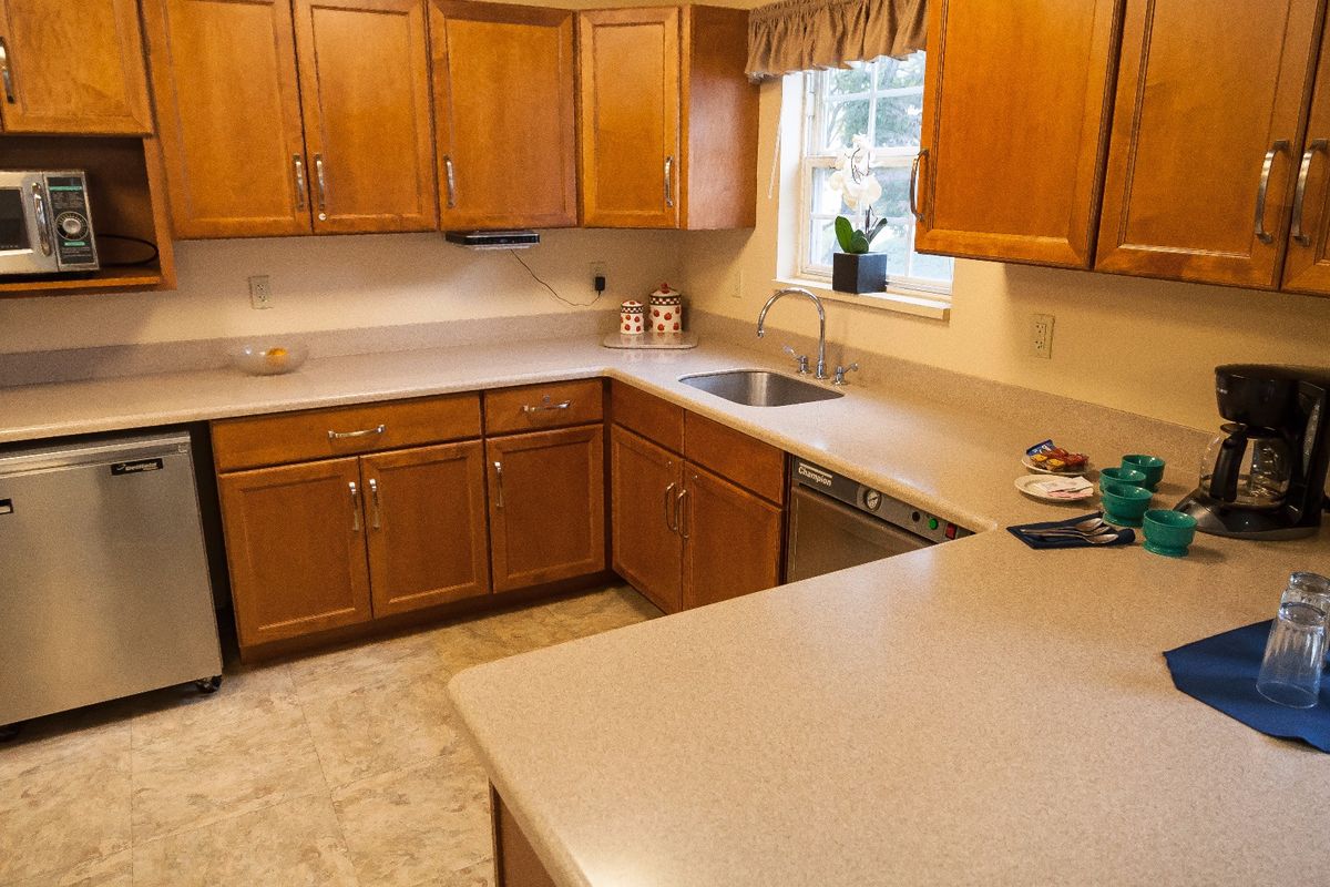 Interior view of Arden Courts senior living kitchen with appliances, furniture, and medication.