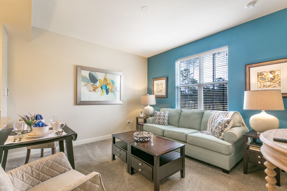 Interior view of St. Anthony's Gardens senior living room with modern furniture and decor.