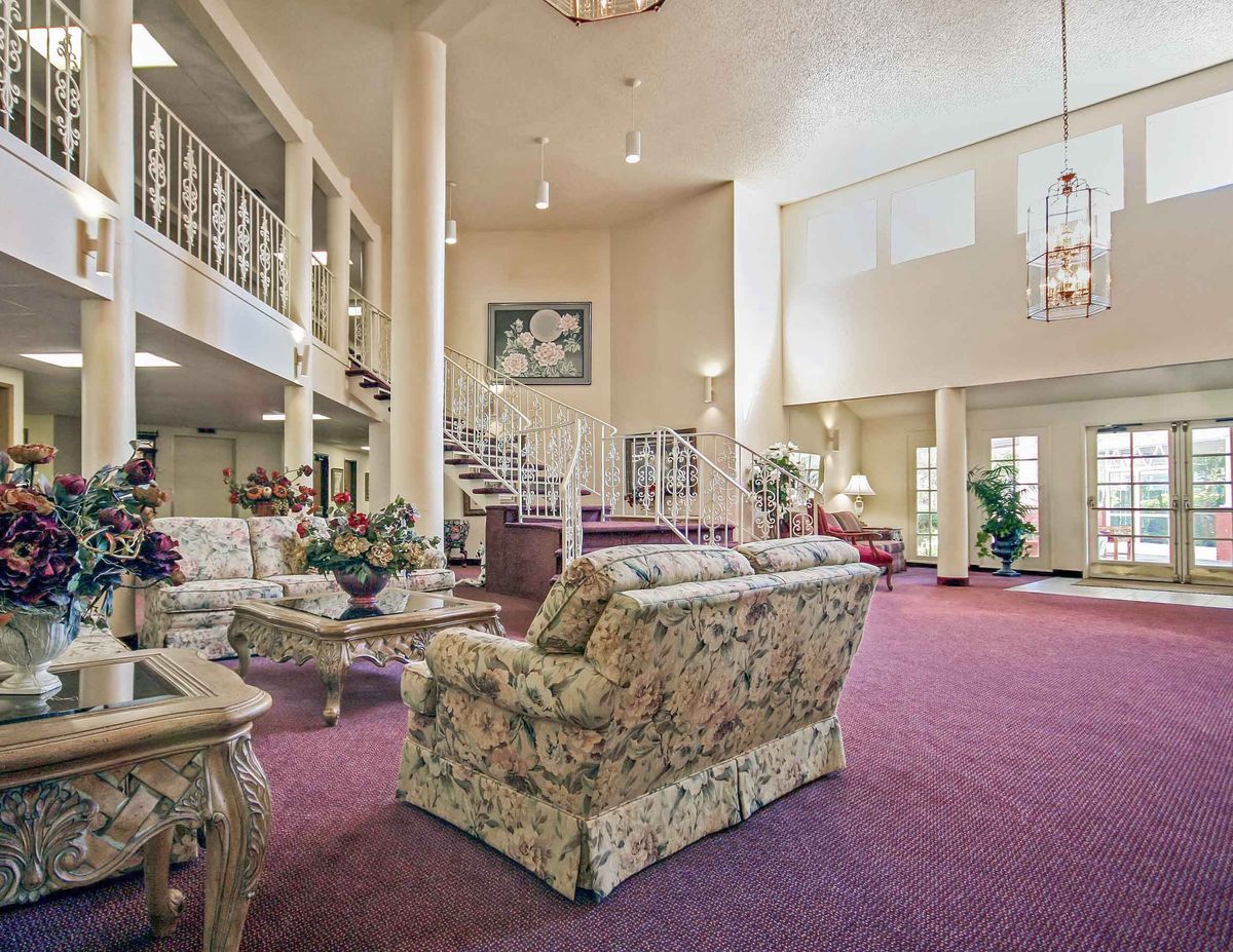 Senior living community Nouveau Marc featuring elegant architecture, cozy living room with stylish decor.