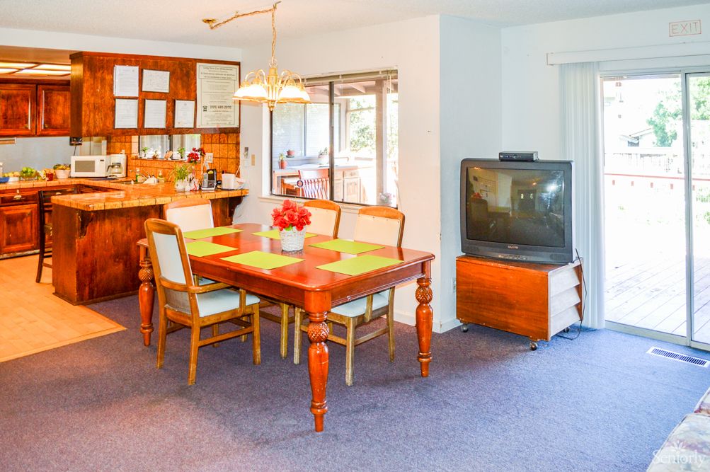 Interior view of Camino Ramon Home for Seniors featuring dining area, living room, and kitchen.
