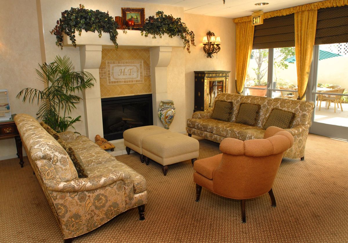 Senior living room interior at Harbor Terrace Retirement Center, San Pedro with cozy furniture and art.