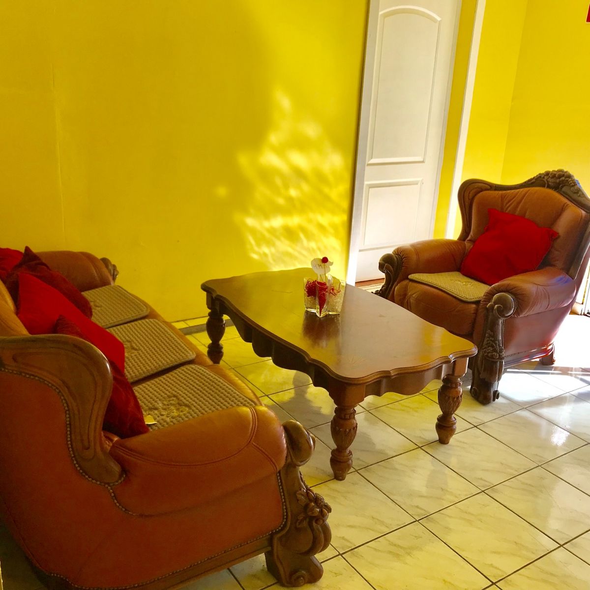 Interior view of Happy Home Care For Elderly, featuring a cozy living room with wooden furniture.