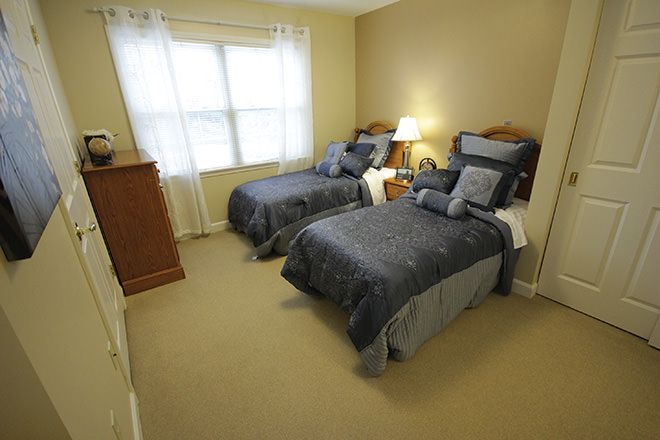 Senior living community Brookdale Meridian featuring furnished bedroom with modern flooring.