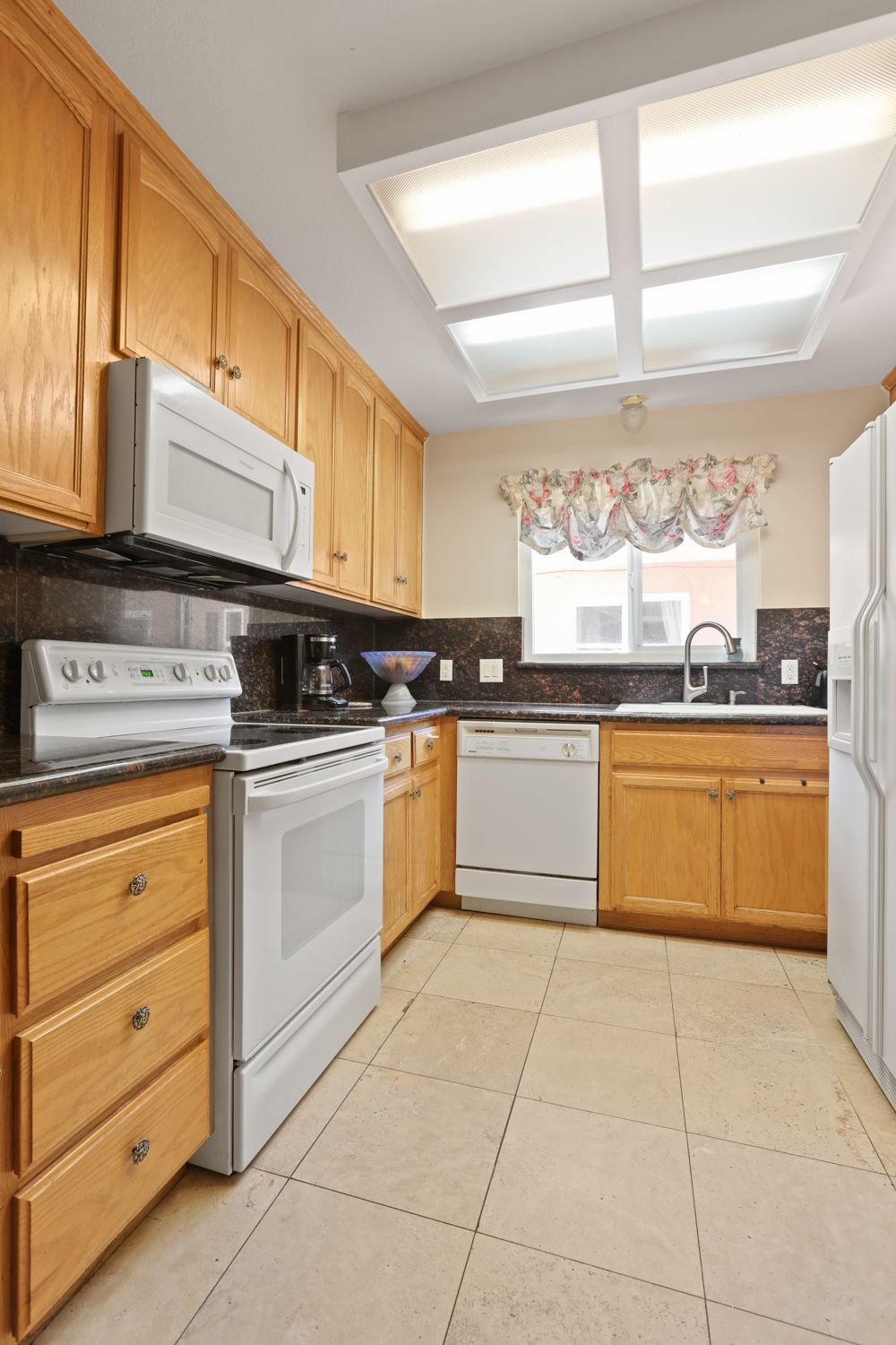 Interior view of Robert Creek Villa II senior living community featuring a well-equipped kitchen.