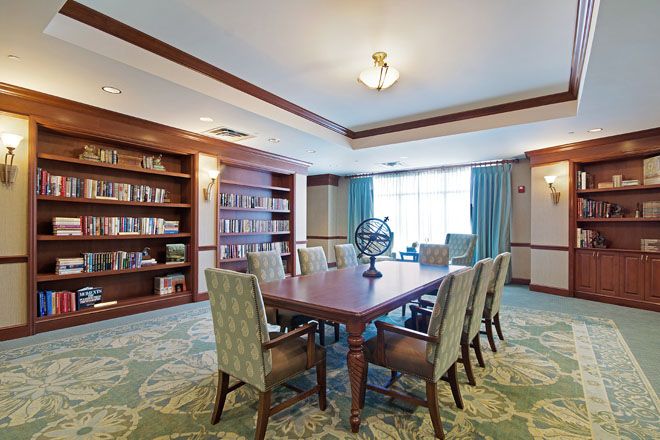 Interior view of Brookdale Creve Coeur senior living community featuring dining room and library.