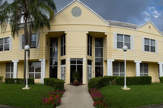 Senior living community Courtyard Plaza with lush lawns, trees, and modern architecture.