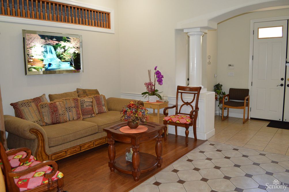 Interior view of Lifeshare Care Home 3, showcasing hardwood flooring, furniture, and home decor.