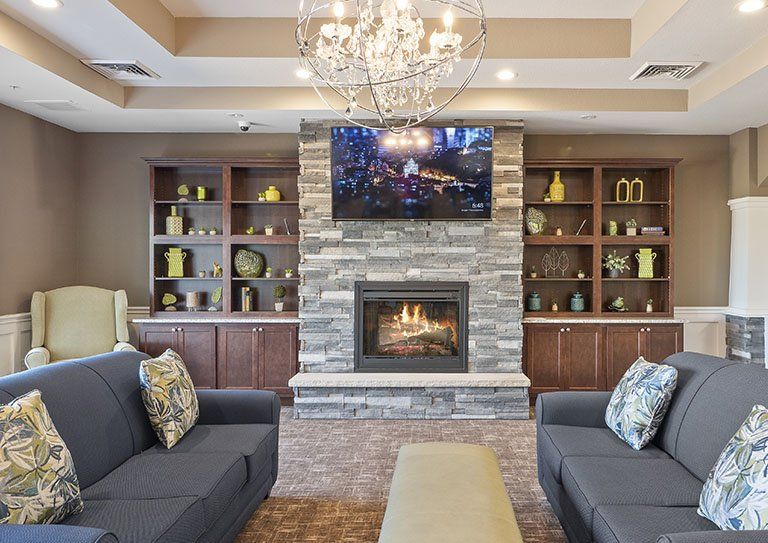 Interior view of Hampton Manor senior living room with elegant decor, fireplace, and modern amenities.