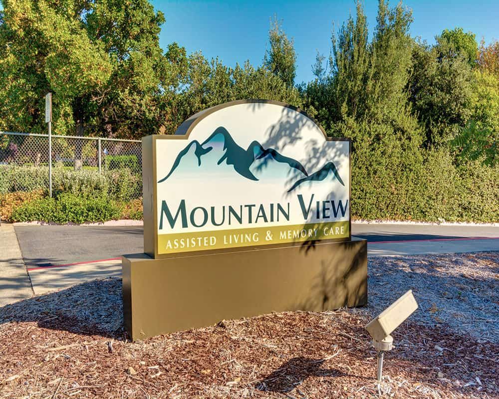 Mountain View Assisted Living & Memory Care community amidst lush greenery and trees.
