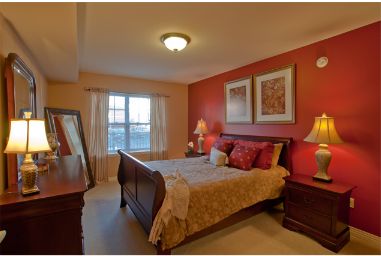 Interior view of a cozy bedroom in Smith Village senior living community with elegant furniture.
