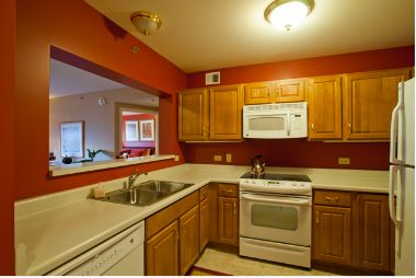 Interior view of Smith Village senior living community featuring a well-designed kitchen with wooden furniture.