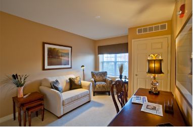 Interior view of Smith Village senior living room with elegant furniture and floral decor.