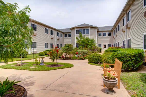 Suburban senior living community, Court At Round Rock, showcasing its architecture and outdoor spaces.