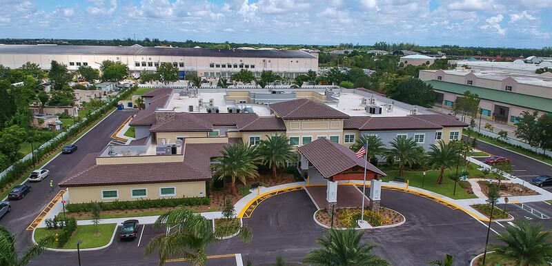 Aerial view of The Monarch senior living community in Coconut Creek, showcasing urban architecture.