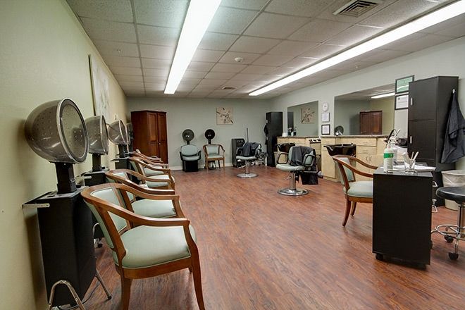 Senior living community interior at Smithfield Woods featuring a beauty salon, barbershop, and art.