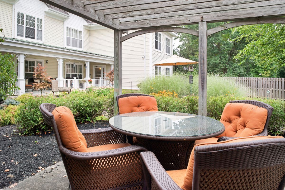 Senior living community Sunrise of Morris Plains featuring patio, pergola, and interior design.