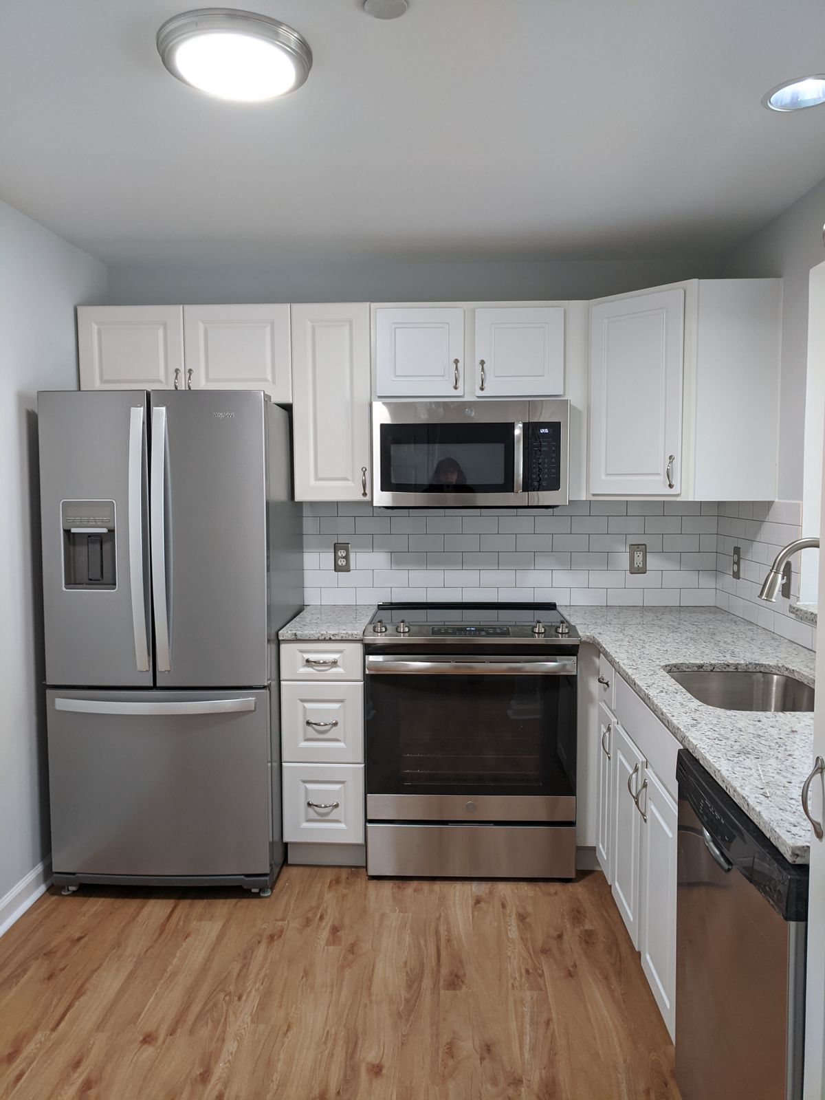 Senior resident in a well-designed kitchen with modern appliances at Lions Gate community.