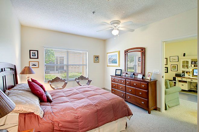 Interior view of a furnished bedroom at Madison At Clermont senior living community.