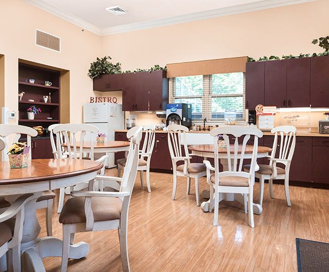 Interior view of Spring Oak of Berlin's senior living community cafeteria with wooden furniture.