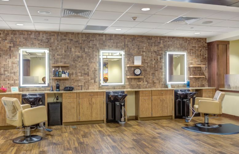 Senior residents enjoying amenities at The Moorings of Arlington Heights, featuring a barbershop and beauty salon.