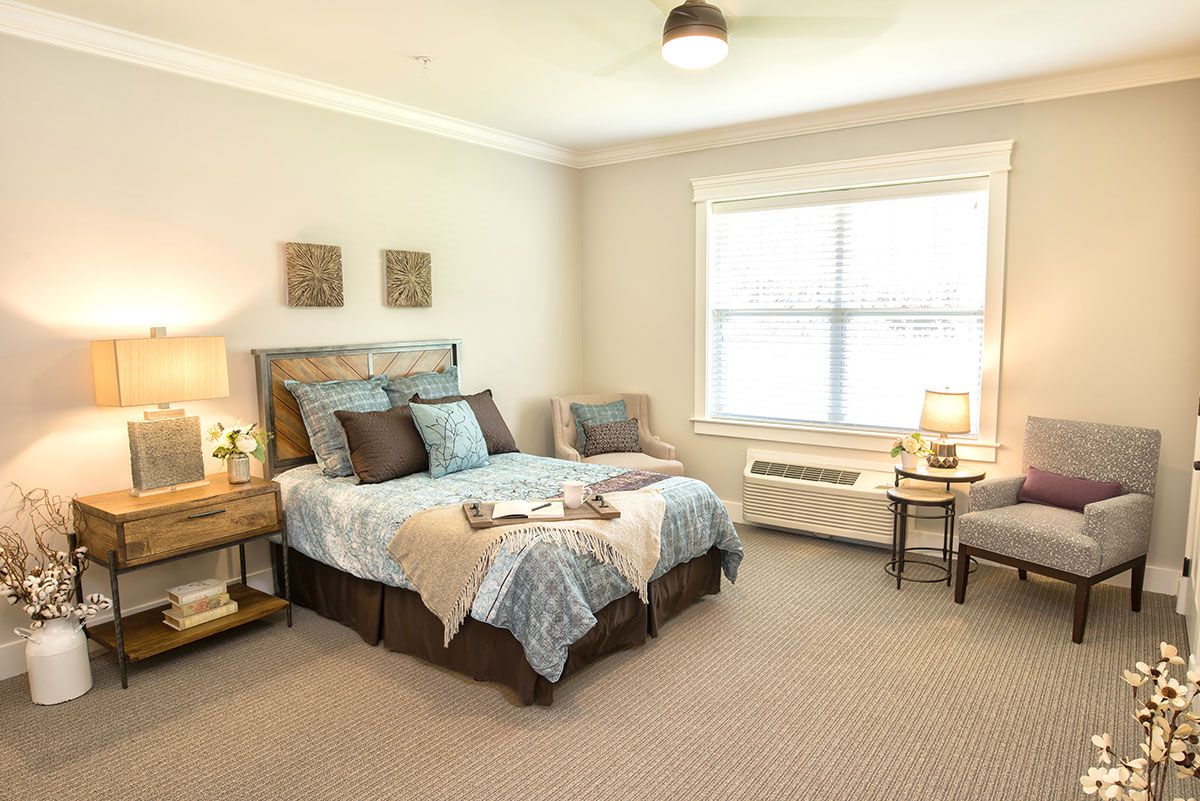 Interior view of a furnished bedroom at Dominion Senior Living of Athens with modern decor.