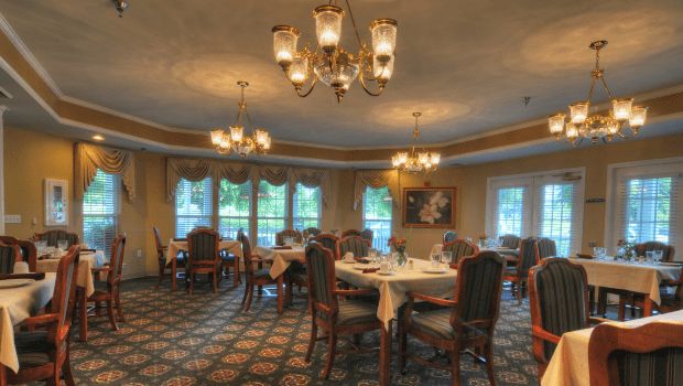 Interior view of Charter Senior Living of Gallatin featuring elegant dining room with chandelier.