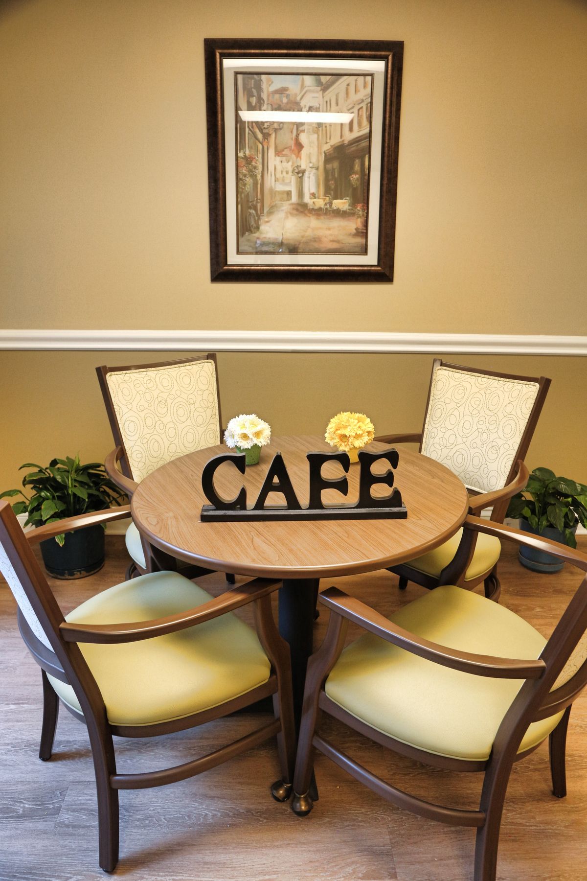 Senior living community Heritage Oaks' architectural building with indoor dining room, furniture, and art.