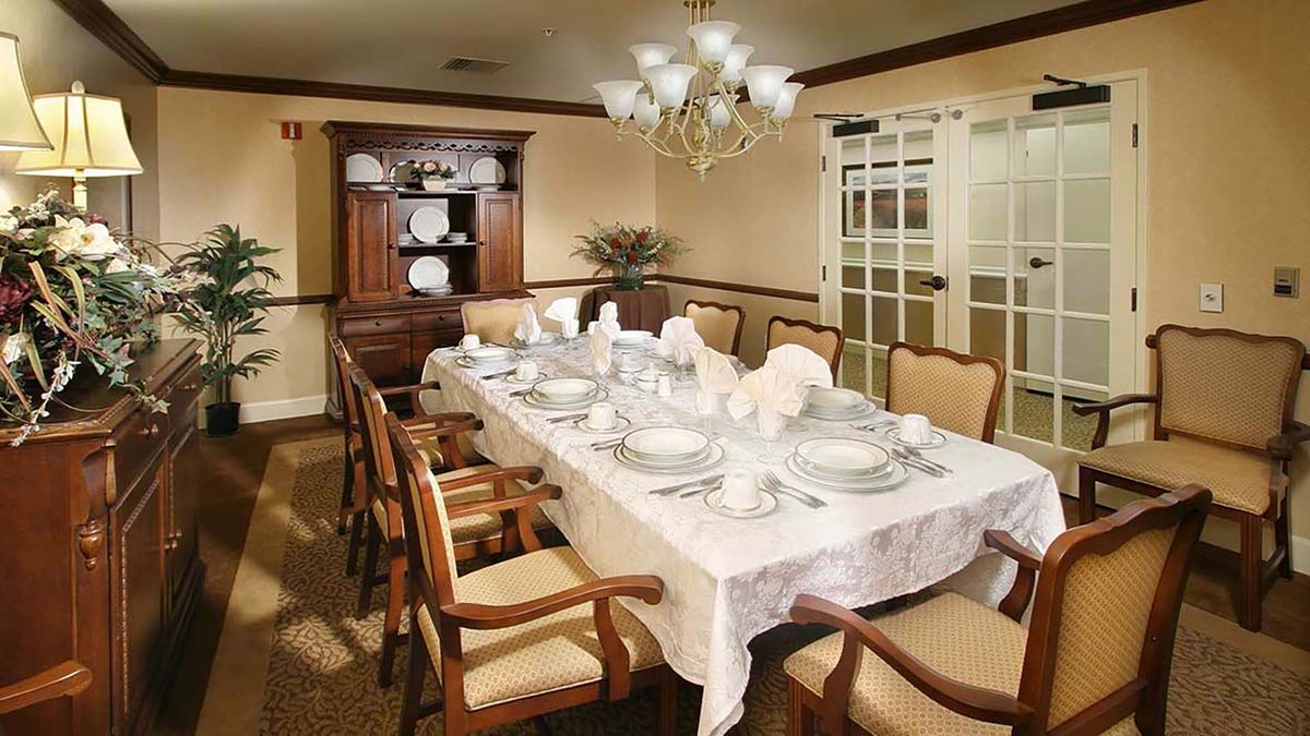 Interior view of Atria Las Posas senior living community featuring dining room decor and furniture.