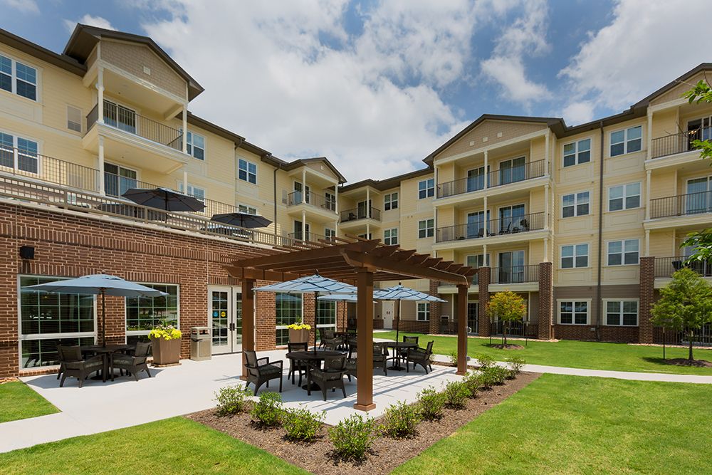 Senior living community, The Enclave at Cedar Park, featuring urban architecture, housing with patios and pergolas.
