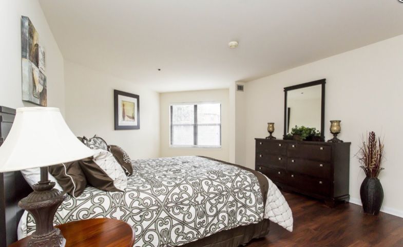 Bedroom interior at Fountains at Cedar Parke senior living community with chic decor.