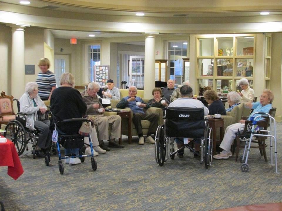 Senior men and women socializing in the communal area at United Methodist Communities At Collingswood.