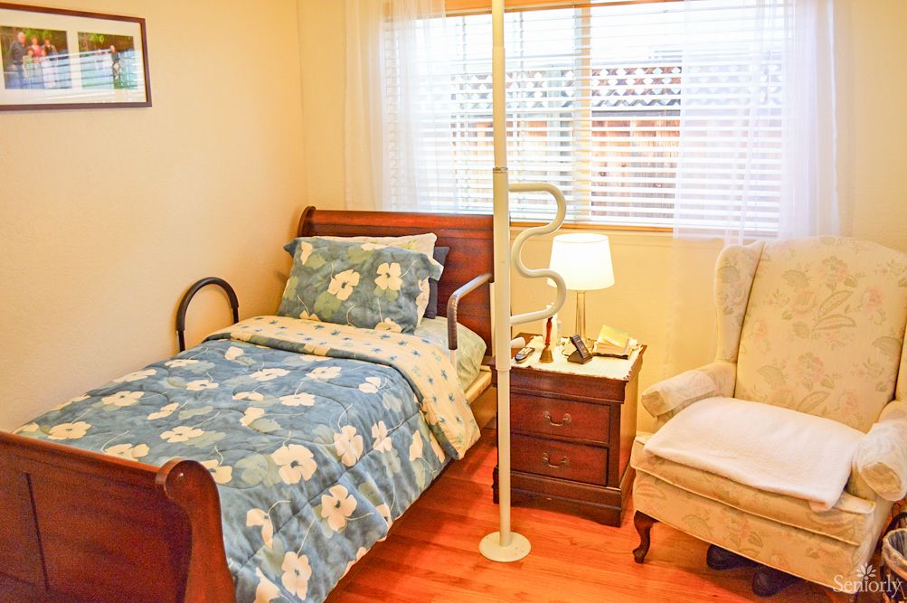 Senior living community bedroom at Harvy's Home Care featuring wooden furniture and home decor.