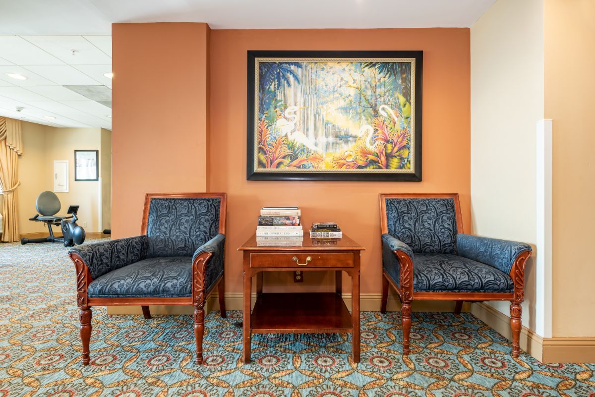 Interior view of Sterling Aventura senior living community featuring art-filled reception room.