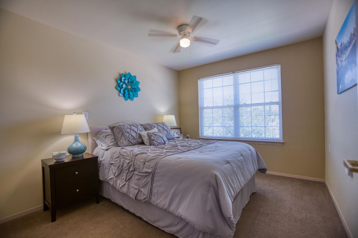 Interior view of a bedroom at Prestige Assisted Living At Green Valley with modern amenities.