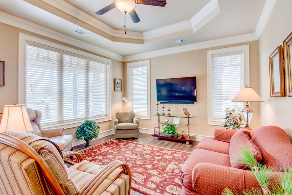 Interior view of Village on the Park Bentonville senior living room with modern decor and electronics.